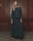 Lattice Lace Victorian Skirt by The Great Inc. in a classic wood-paneled room with patterned carpet.