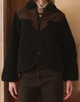 The Great Inc. Reversible Western Yoke Pasture Jacket layered over a striped shirt, styled indoors.