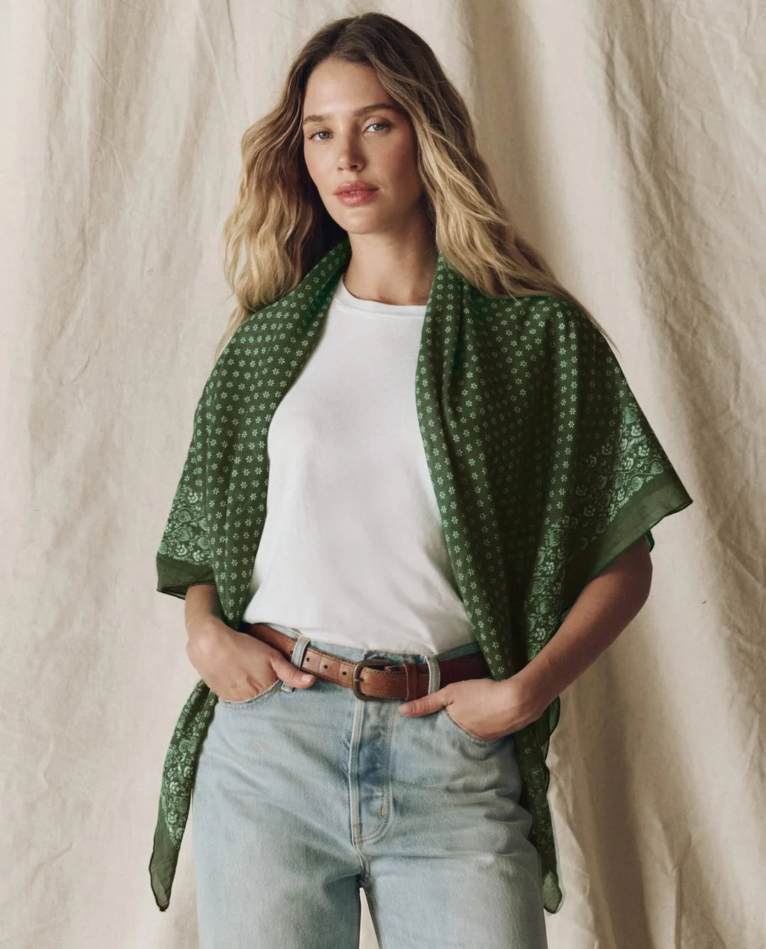 The Big Bandana draped over shoulders, featuring a large vintage green handkerchief with a white floral pattern.