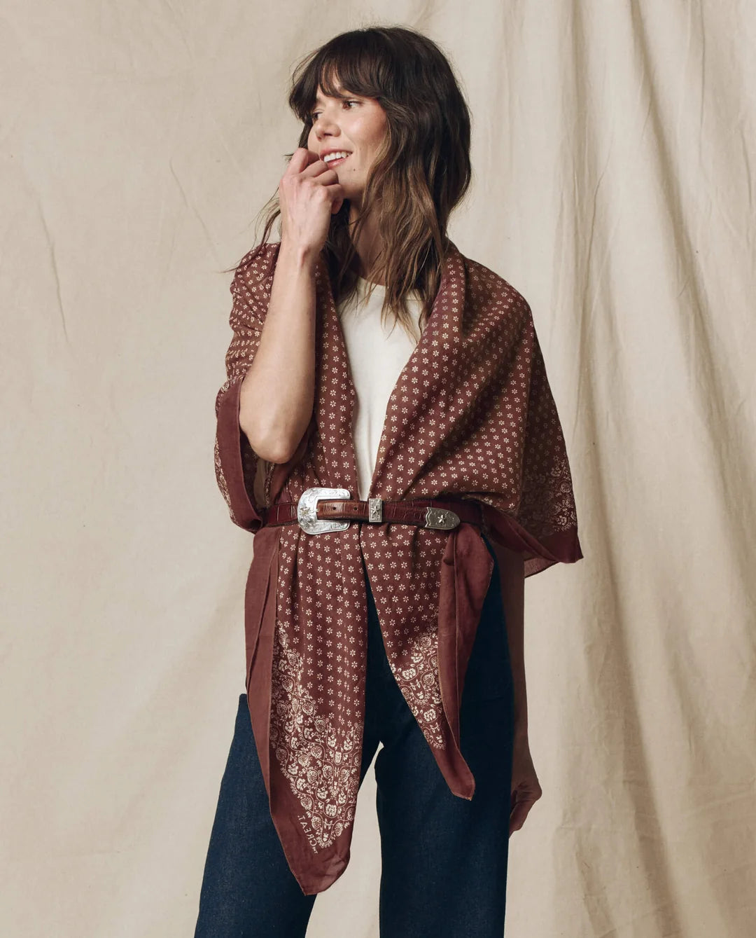 The Big Bandana worn as a cape over a white shirt and jeans with a belt, Bungalow Furniture &amp; Accessories style.