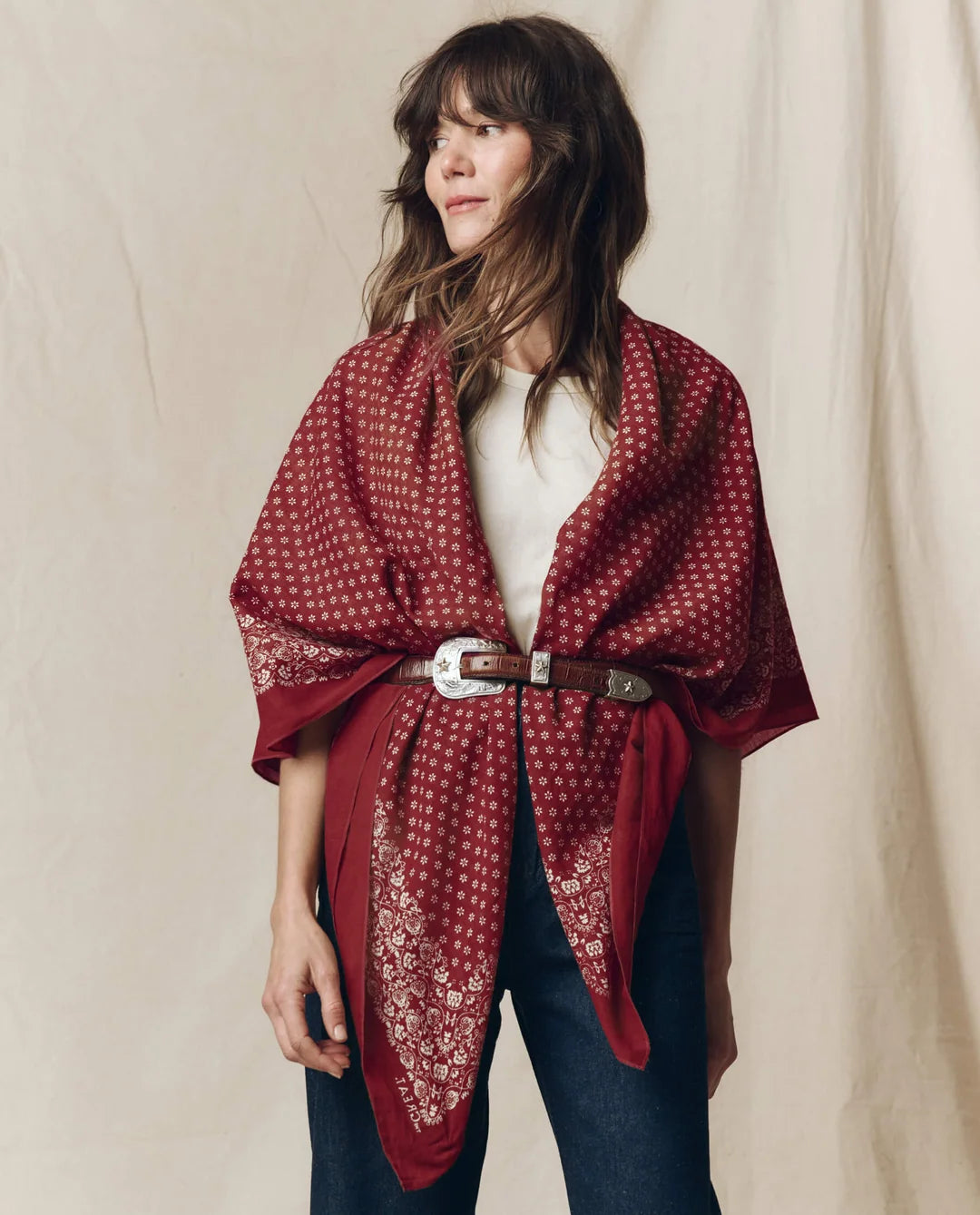 Red floral vintage-style Big Bandana draped over shoulders and cinched with a silver-buckled leather belt.