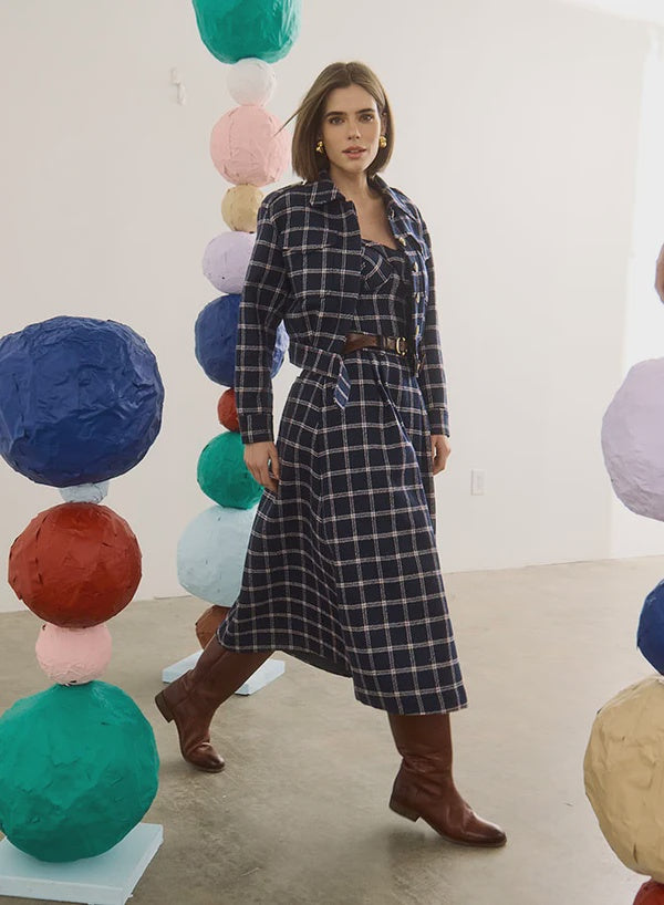 Dorrington Jacket by Hunter Bell NYC styled with brown boots, vibrant paper spheres create a playful lifestyle setting.