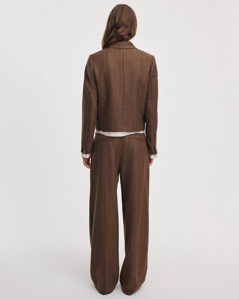 Lawrence tailored pant and pinstripe blazer in brown herringbone, worn from behind.