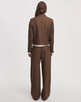 Lawrence tailored pant and pinstripe blazer in brown herringbone, worn from behind.
