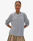Clare Vivier blue and cream striped long sleeve tee styled with a pleated skirt, casual modern look.