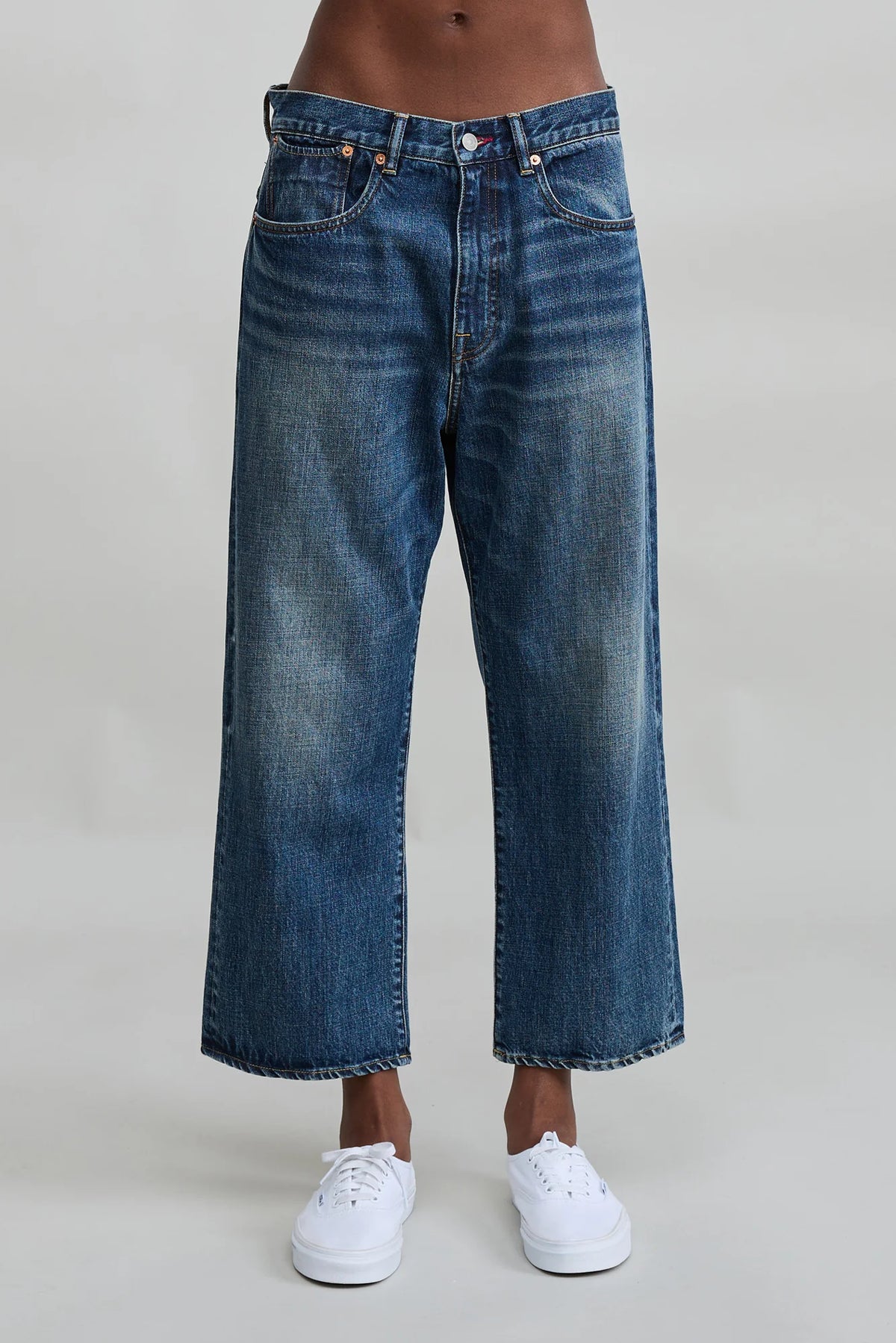 Denimist Haisley Slouch BF Sloane Indigo jeans styled with white sneakers, shown on model, light gray background.