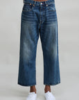 Denimist Haisley Slouch BF Sloane Indigo jeans styled with white sneakers, shown on model, light gray background.