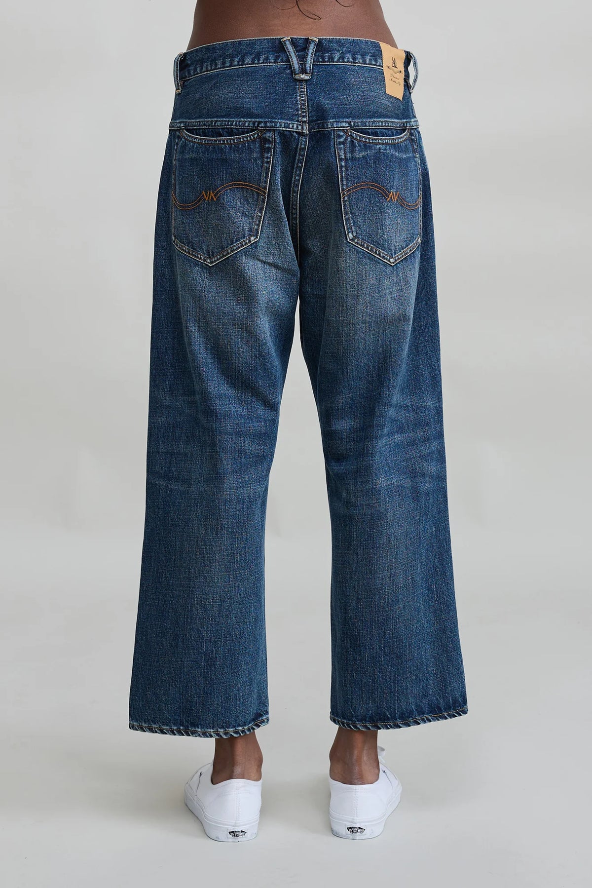 Denimist HAISLEY SLOUCH BF jeans in Sloane Indigo shown from the back, styled with white slip-on shoes.
