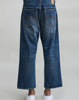 Denimist HAISLEY SLOUCH BF jeans in Sloane Indigo shown from the back, styled with white slip-on shoes.