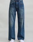 Denimist ALLFIT JEAN with white sneakers, casual style against a light neutral background.