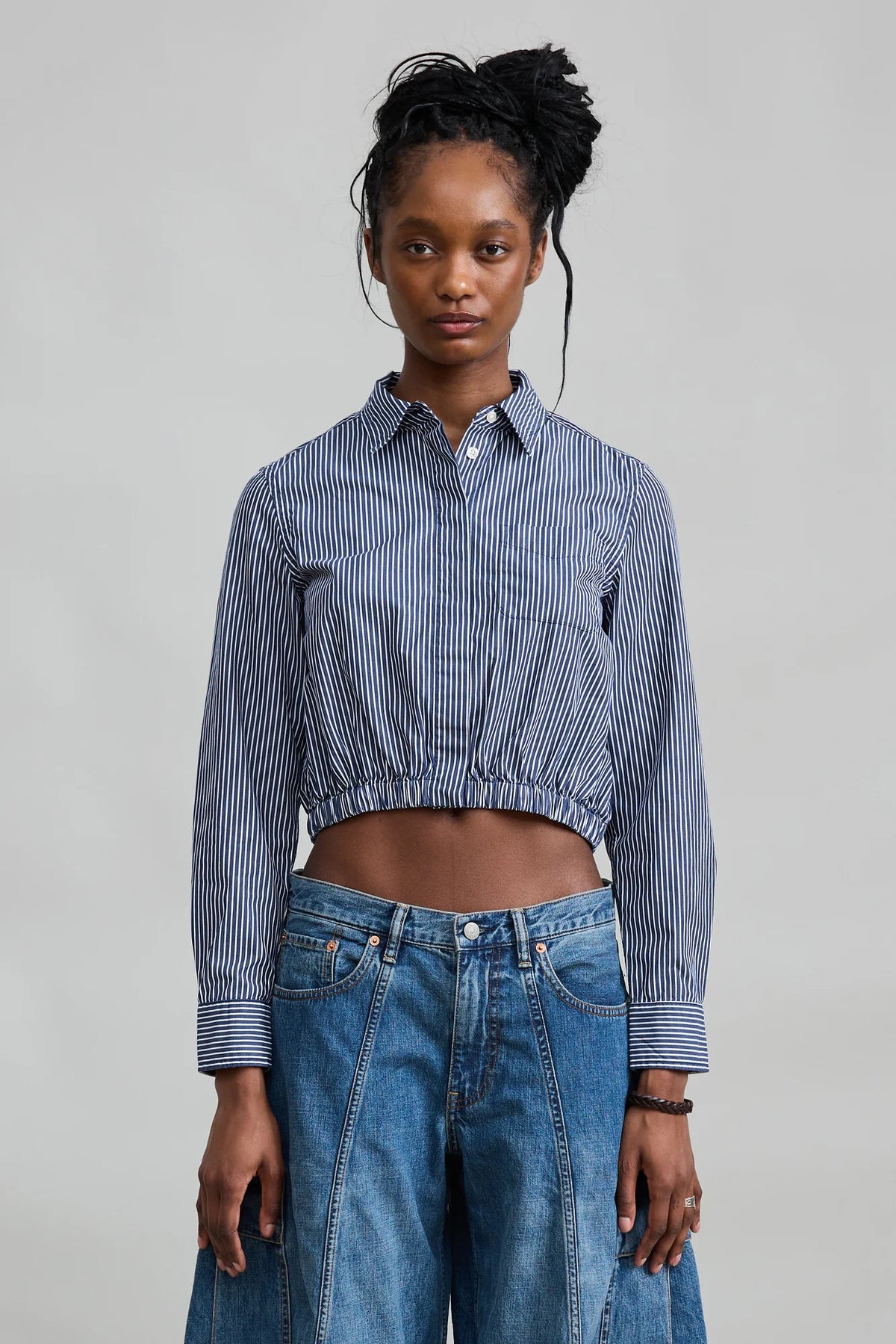 Denimist cropped elastic waist shirt with wide-leg jeans, shown in a minimal studio setting for Bungalow Furniture.