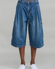 Ainsley triple pleat cargo shorts with oversized flap pockets by Denimist, styled with white sneakers.