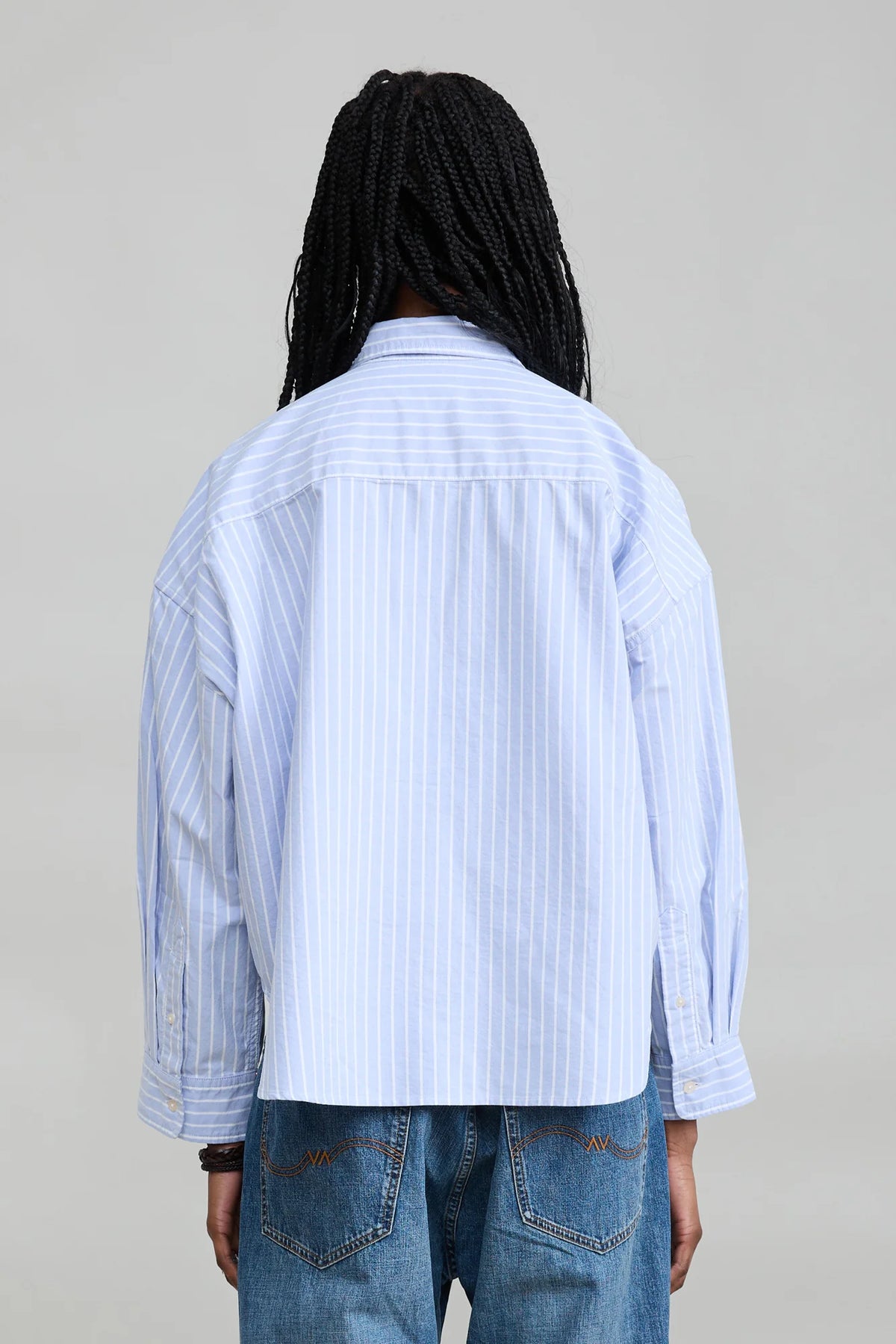 Denimist Bailey Cropped Stripe Oxford shirt in blue stripes, back view, styled with blue jeans.