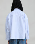 Denimist Bailey Cropped Stripe Oxford shirt in blue stripes, back view, styled with blue jeans.