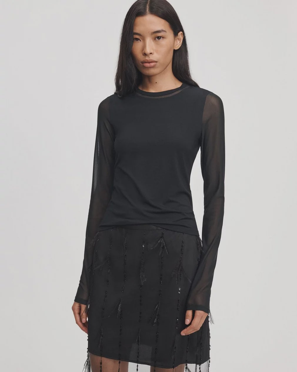 Fitted mesh long-sleeve top by Rag &amp; Bone in Luca Shadow worn with a black embellished skirt.