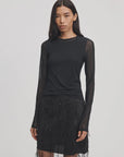 Fitted mesh long-sleeve top by Rag & Bone in Luca Shadow worn with a black embellished skirt.
