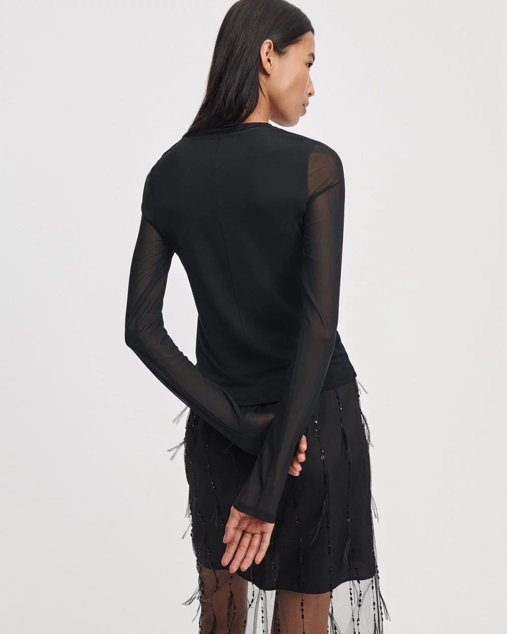 Luca Shadow LS jersey top with sheer mesh sleeves and sequined fringe skirt.