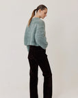 Maiami Wool Alpaca Mix Cropped Pullover in light blue worn with dark corduroy pants.