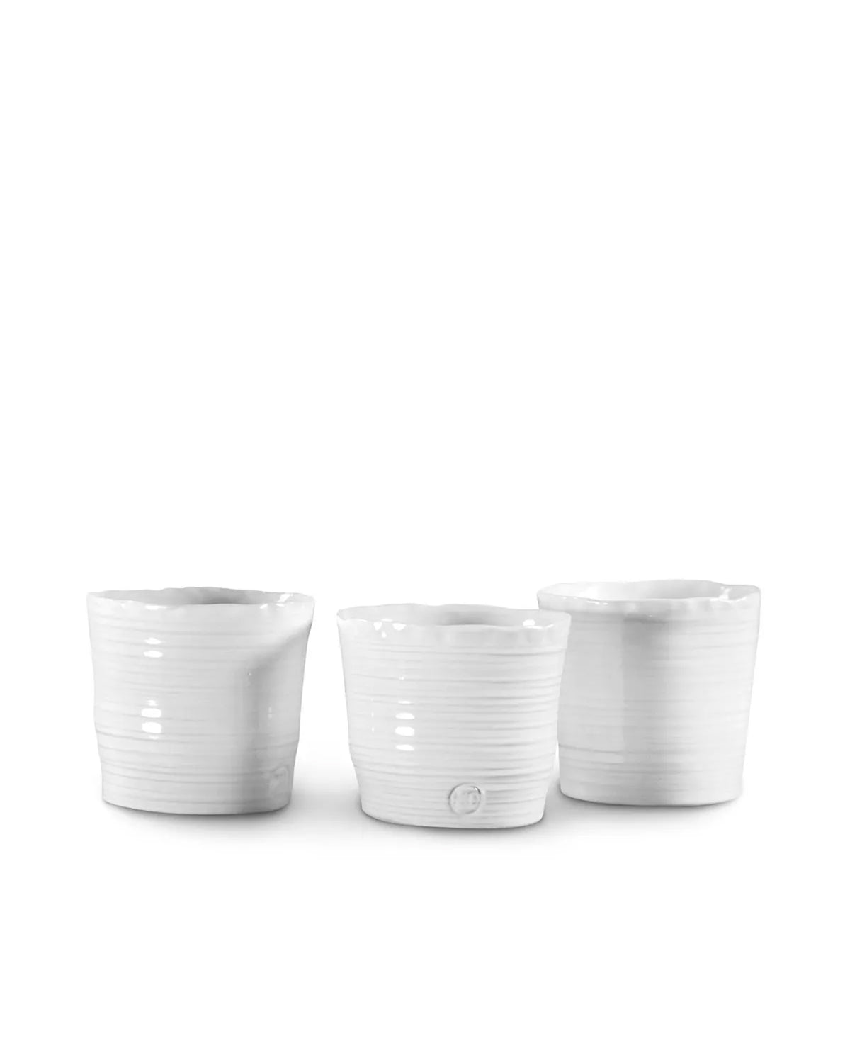 Three Tumbler No. 79 cups by Montes Doggett, crafted from high-fired white ceramic with a subtly ridged, handmade look, are shown side by side on a plain white background. They are both microwave and dishwasher safe.