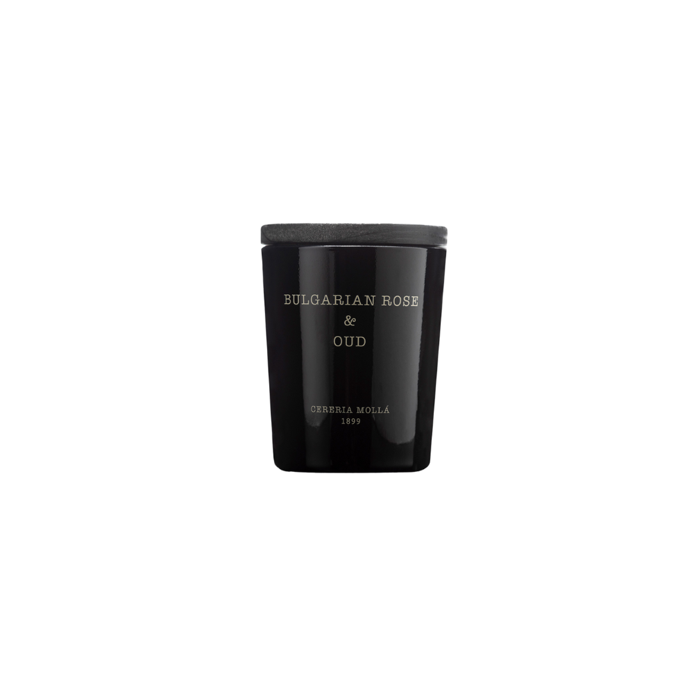 The Cereria Molla Bulgarian Rose & Oud Candle is a black glass jar with a black lid, filled with luxurious soy wax and displayed against a plain light background.