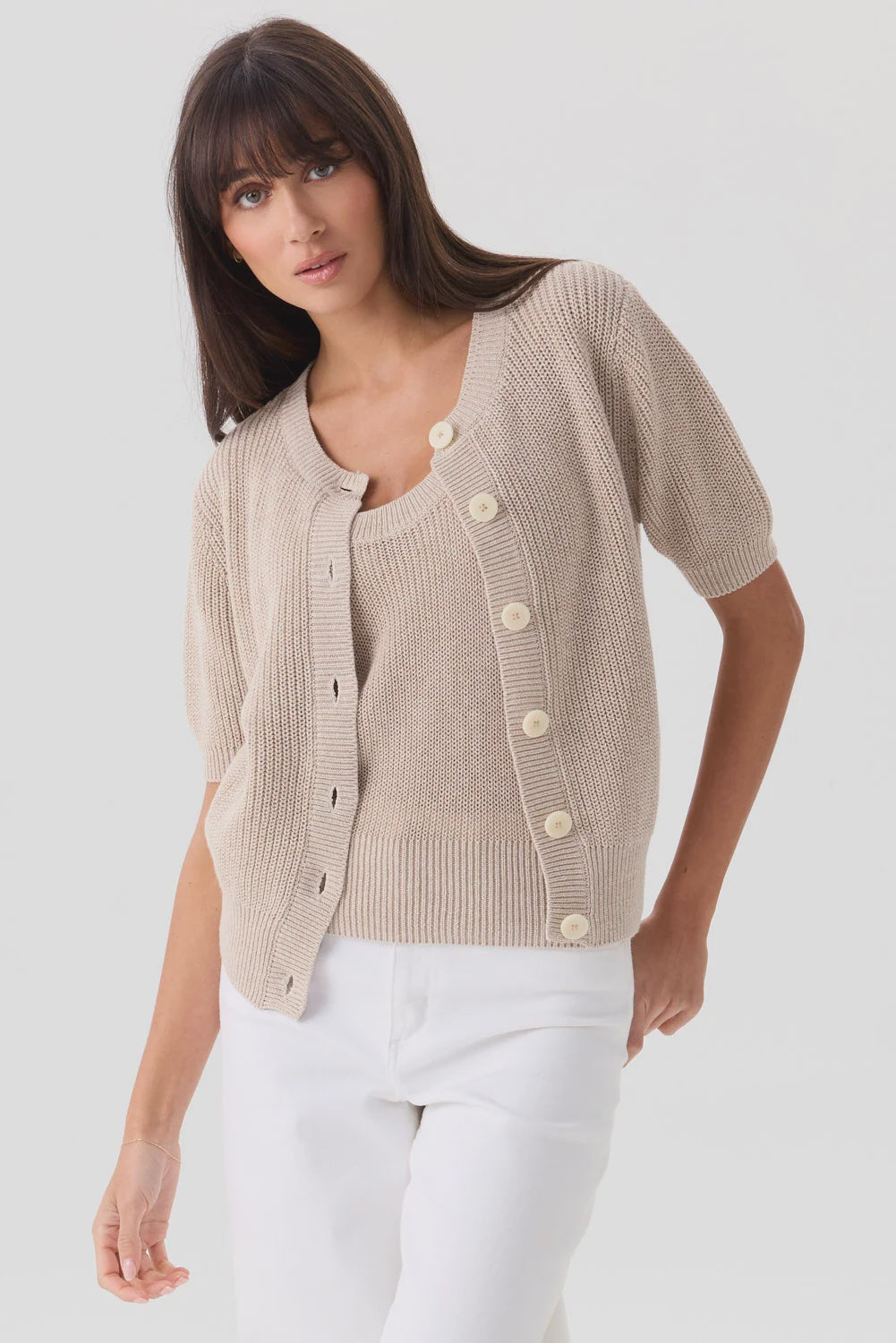 Mia Fratino Cashmere Rue Relaxed Cardigan and scoop-neck top in beige worn with white pants.