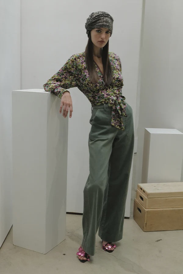 Everyday Brenda Tux Pant in sage green worn with a floral wrap top and a sequined headscarf.