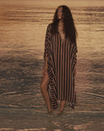 Natalie Martin Paulina Caftan in sunset light, styled oceanside with sailboats for a breezy, relaxed look.