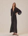 Natalie Martin Sarah Dress in a light setting, styled with sandals, at Bungalow Furniture & Accessories.