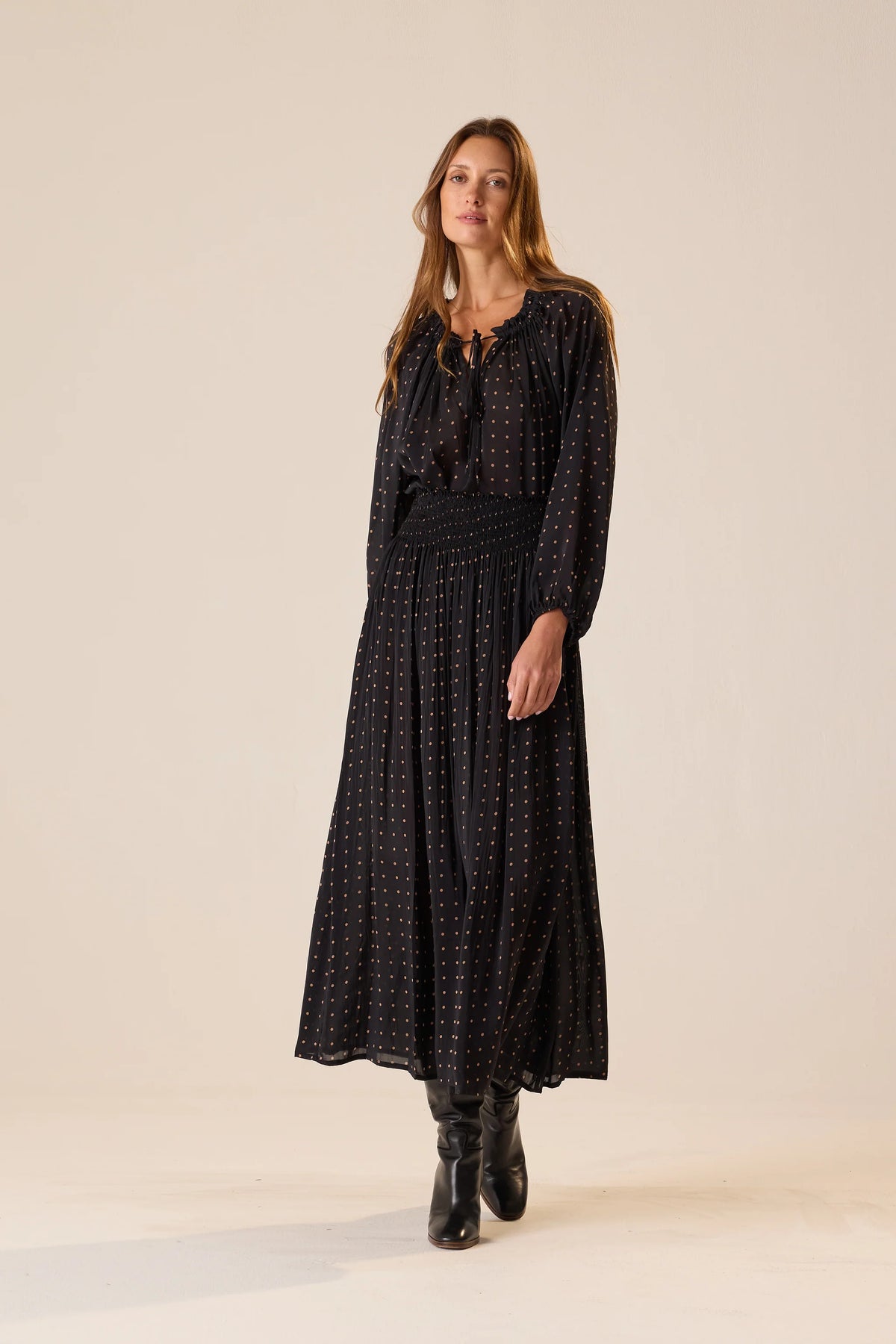 Bella Skirt in Polka Dot Black Tan by Natalie Martin, styled with black boots, shown on a simple backdrop.