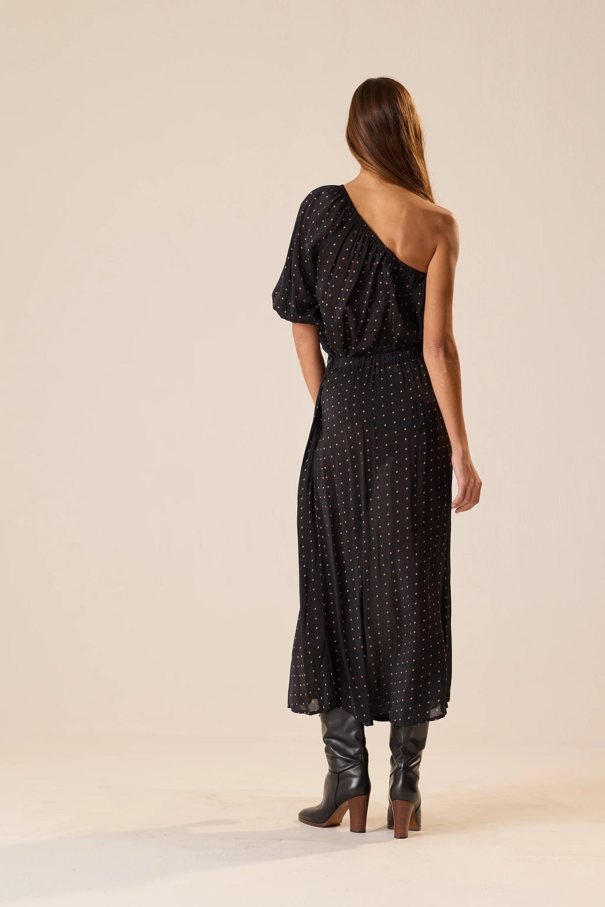 Black one-shoulder polka dot Erin Top by Natalie Martin, 70s-inspired style, shown on model against neutral backdrop.