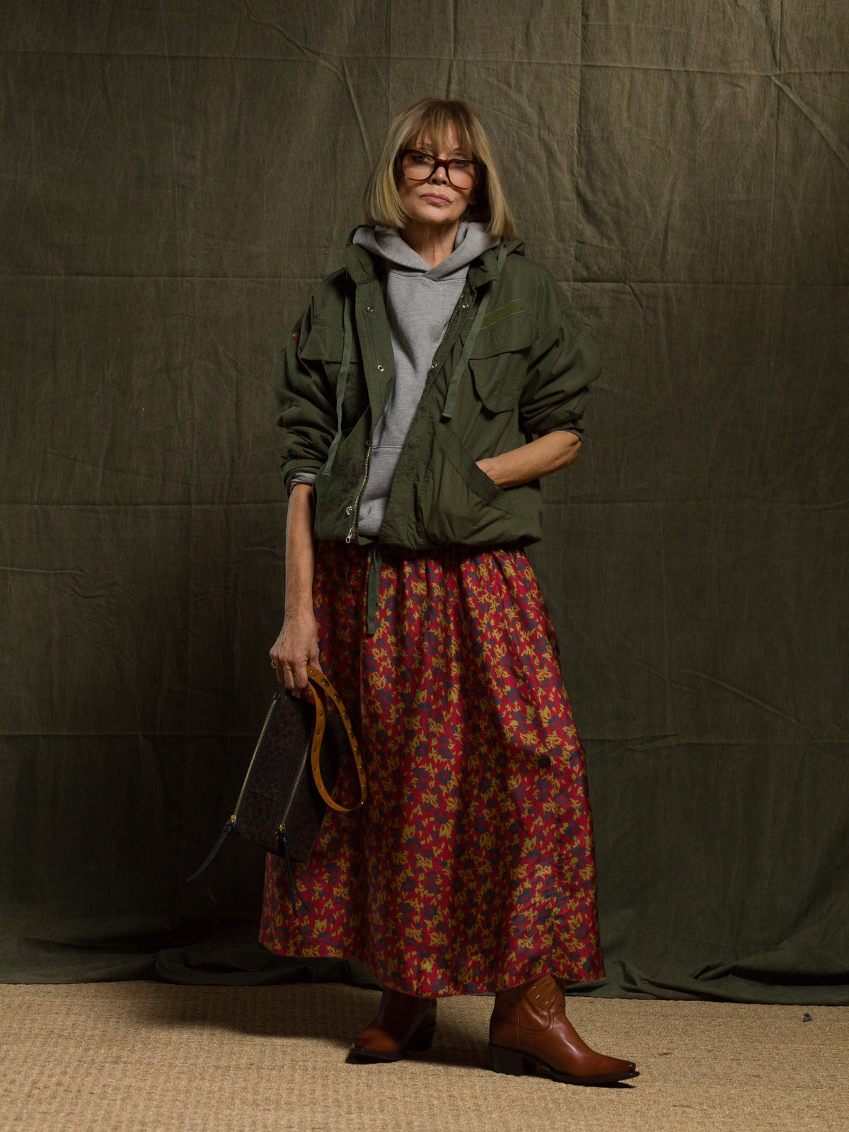 Free City LifeNatureLove zip hoodie styled with a vintage jacket and floral skirt in a cozy indoor setting.