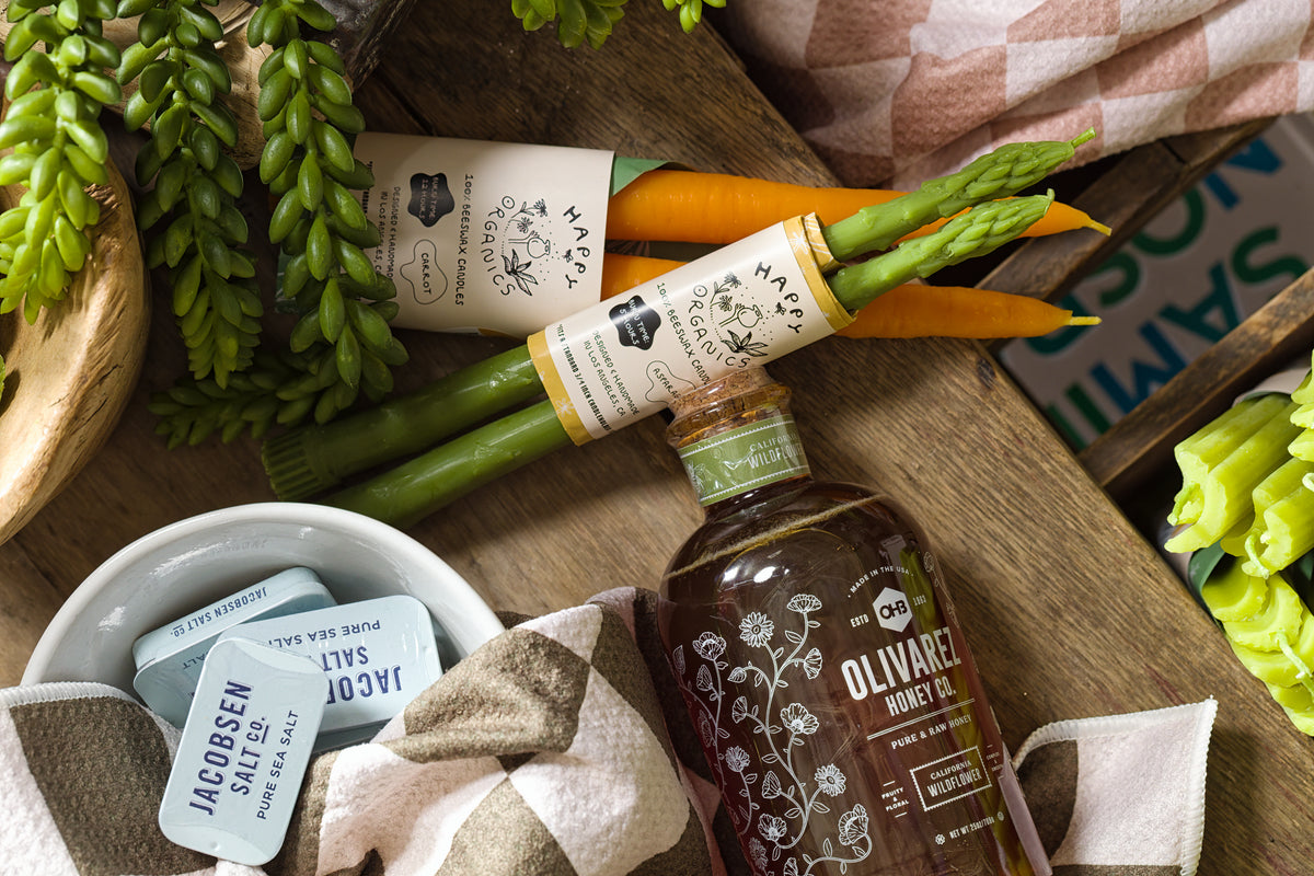 Rustic tray with carrots and asparagus, drizzled with olive oil, styled for Bungalow Furniture & Accessories.