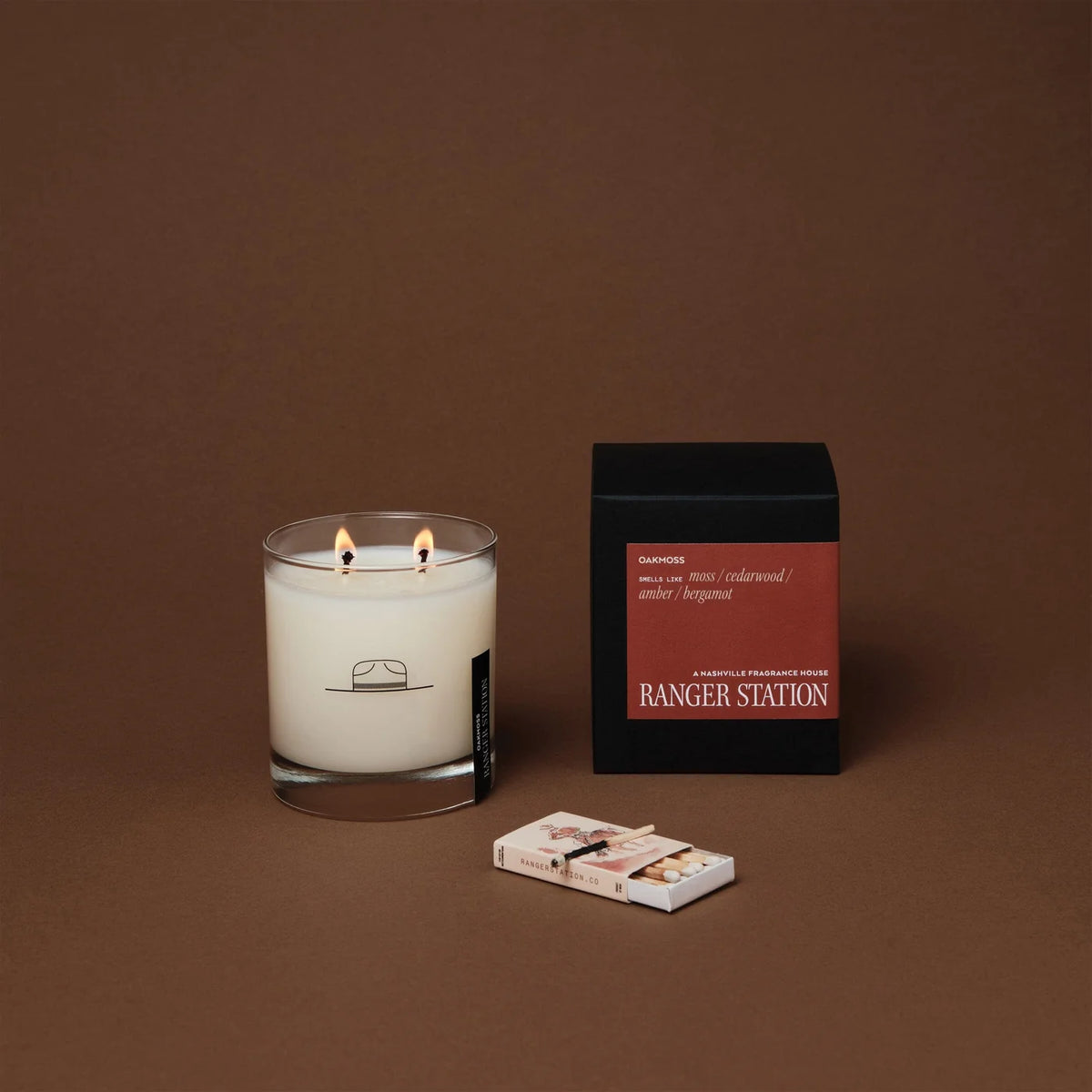 Oak Moss candle in a clear glass jar with a black box and matches by Bungalow Furniture & Accessories.