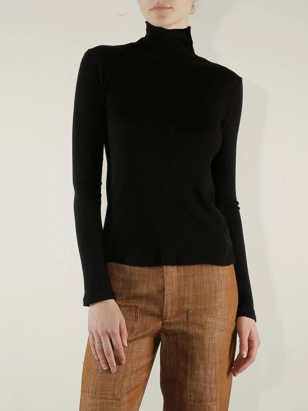 Black ribbed Pharaoh Cleo Turtleneck by Bungalow, lightweight material, modeled against a light background.