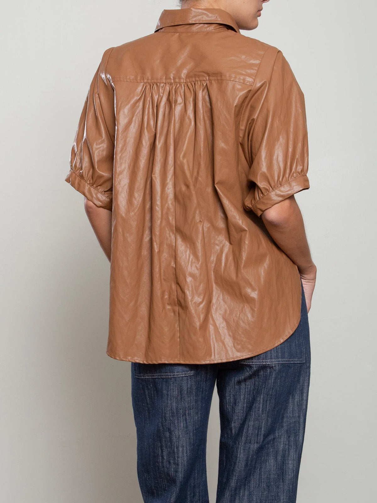 Shiny brown Pharaoh Claude Shirt with voluminous sleeves, styled with dark jeans, Bungalow Furniture & Accessories.