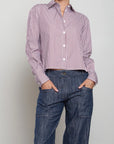 Pharaoh’s Enzo striped poplin shirt in blue, styled with jeans, hands in pockets, simple background.