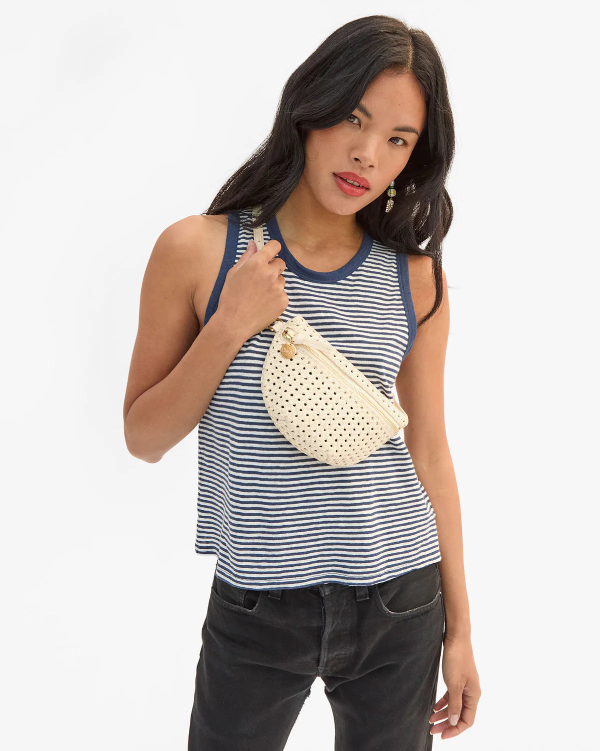 Clare Vivier Petite Fanny S26 white crossbody bag styled with a striped tank and black jeans for a casual look.