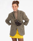 Clare Vivier Petite Fanny S26 bag styled with a brown blazer, tan turtleneck, and yellow skirt.