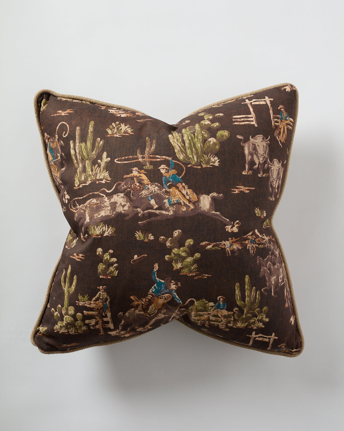 The Design Legacy Brown Cowboy Jute 26x26 pillow features a chocolate brown jute fabric with a vintage cowboy and horse print, including cacti, perfect for adding rustic Western charm to your decor.