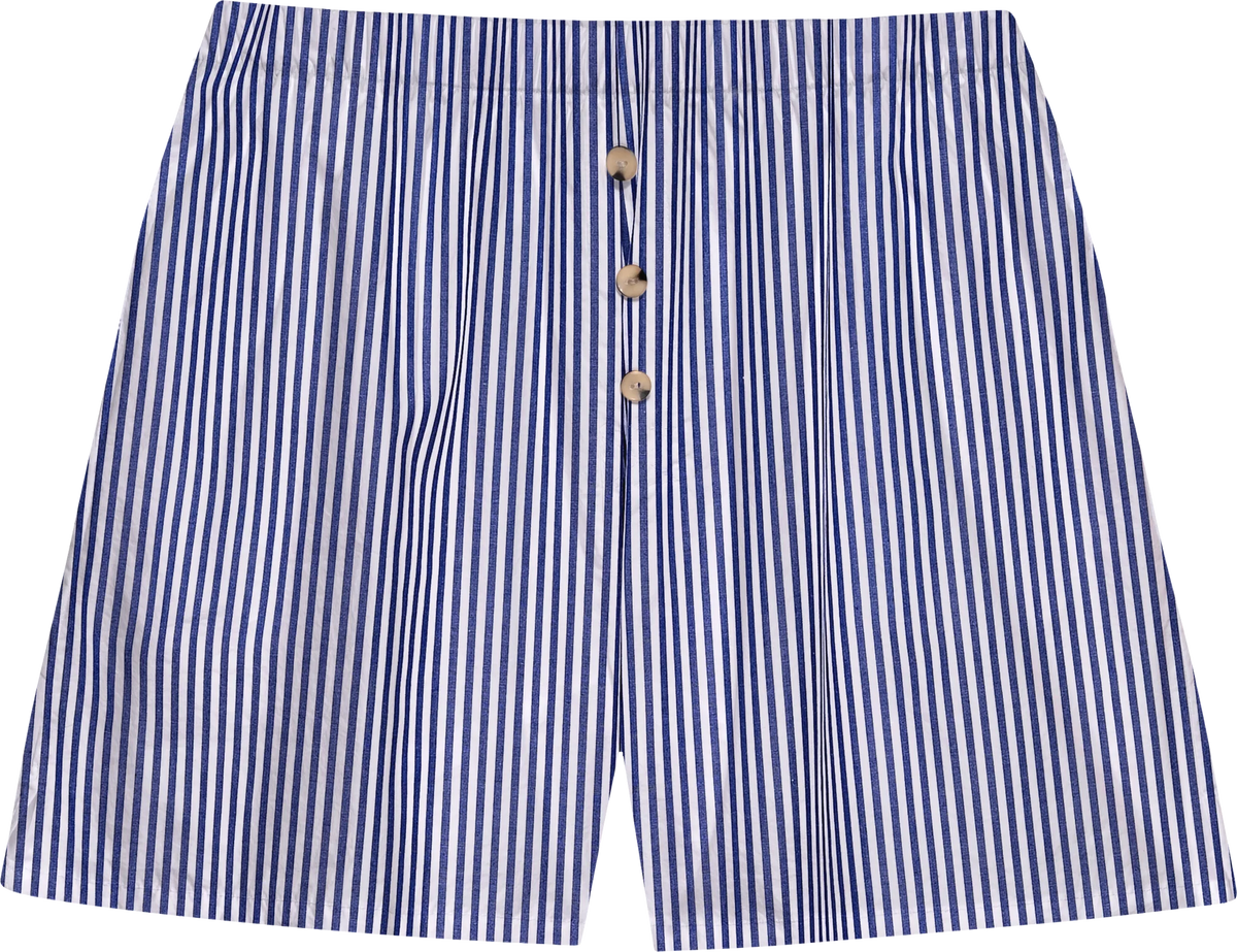 The Stripe Pop Boxer by Donni features blue and white vertical stripes, three brown front buttons, and is made from lightweight, breathable cotton poplin. These men's boxers offer a relaxed fit and are crafted in Los Angeles.