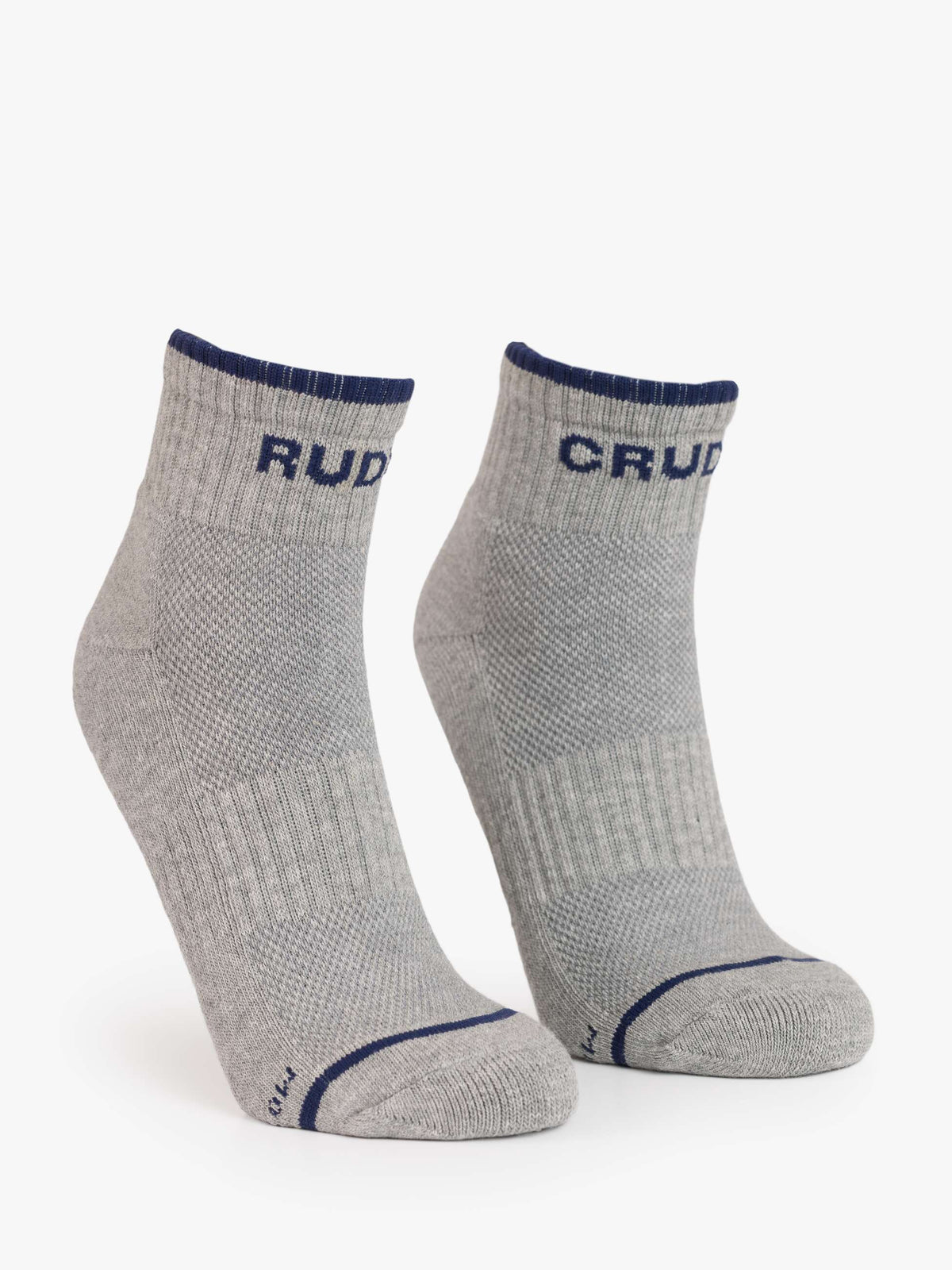 The Mother Baby Steps Ankle socks are light grey with dark blue trim and "CRU" on the cuffs. Featuring a classic tube sock look, they have reinforced toes and heels plus a textured pattern for style and comfort.