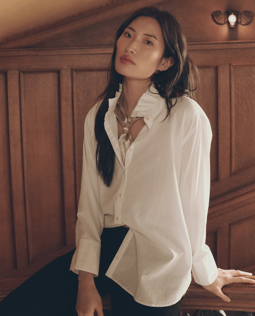Oversized white The Ruffle Neck Shirt with a tied scarf from Bungalow Furniture & Accessories.