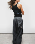 Free City Matte Satin Drawcord Biggy Pant in a relaxed fit, shown from the back, styled casually on concrete floor.