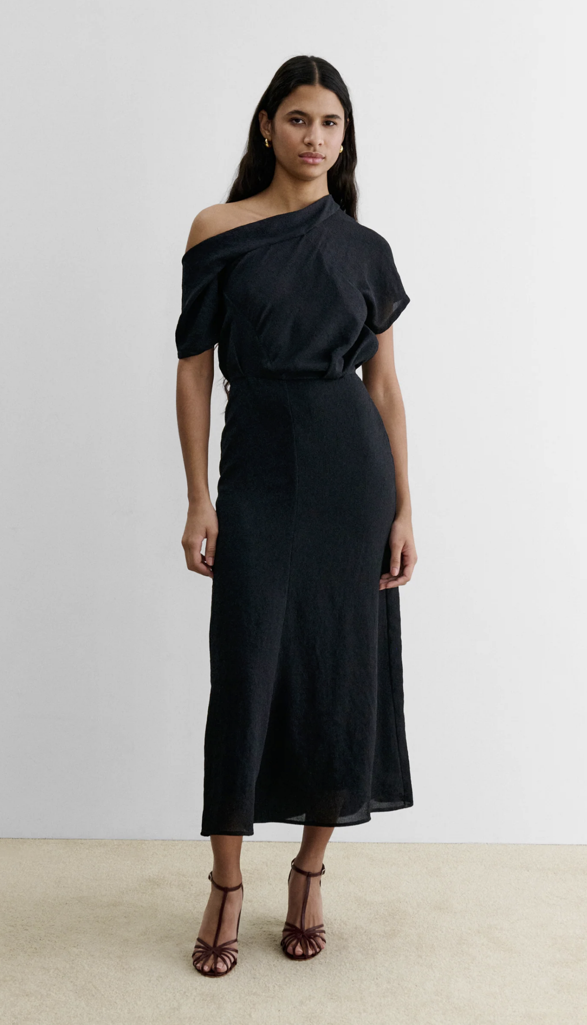 Rachel Comey Pout Dress in black crinkled crepe, styled with brown heels against a white backdrop.