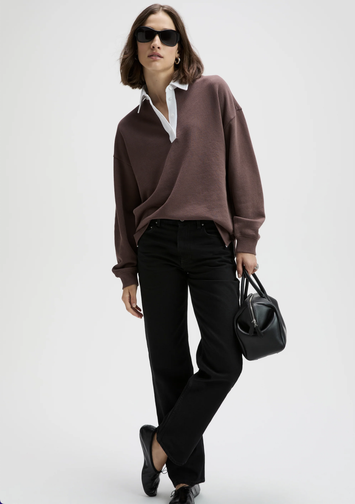 Classic Rugby Polo by Sold Out NYC styled with a crisp white shirt and black accessories for a chic, modern look.