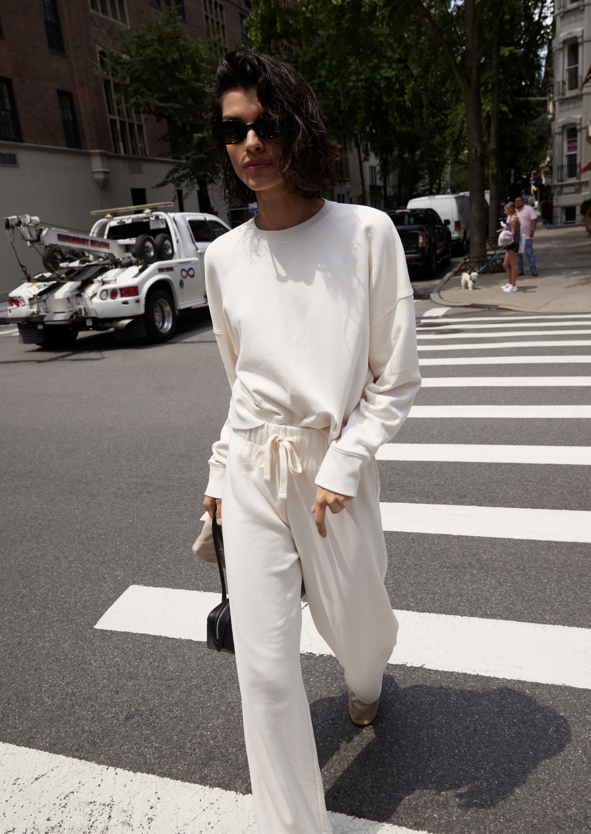 The Everyday Sweatshirt by Sold Out NYC styled for the city, paired with sunglasses and a small handbag.