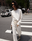 The Everyday Sweatshirt by Sold Out NYC styled for the city, paired with sunglasses and a small handbag.