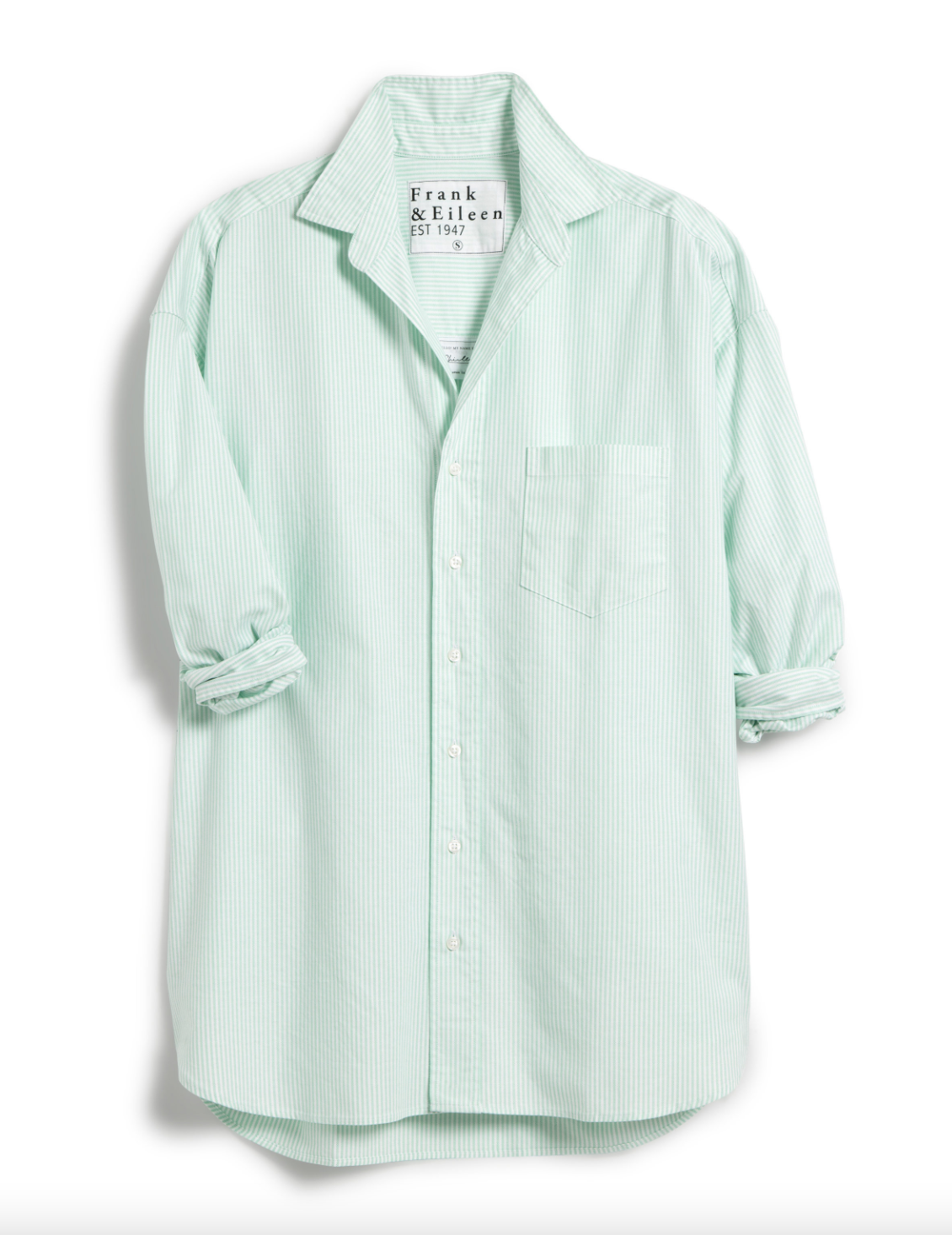 The Shirley Oversized by Frank &amp; Eileen is a light green and white striped, oversized button-up shirt with long rolled sleeves, a chest pocket, and a collar. Displayed on a white background.