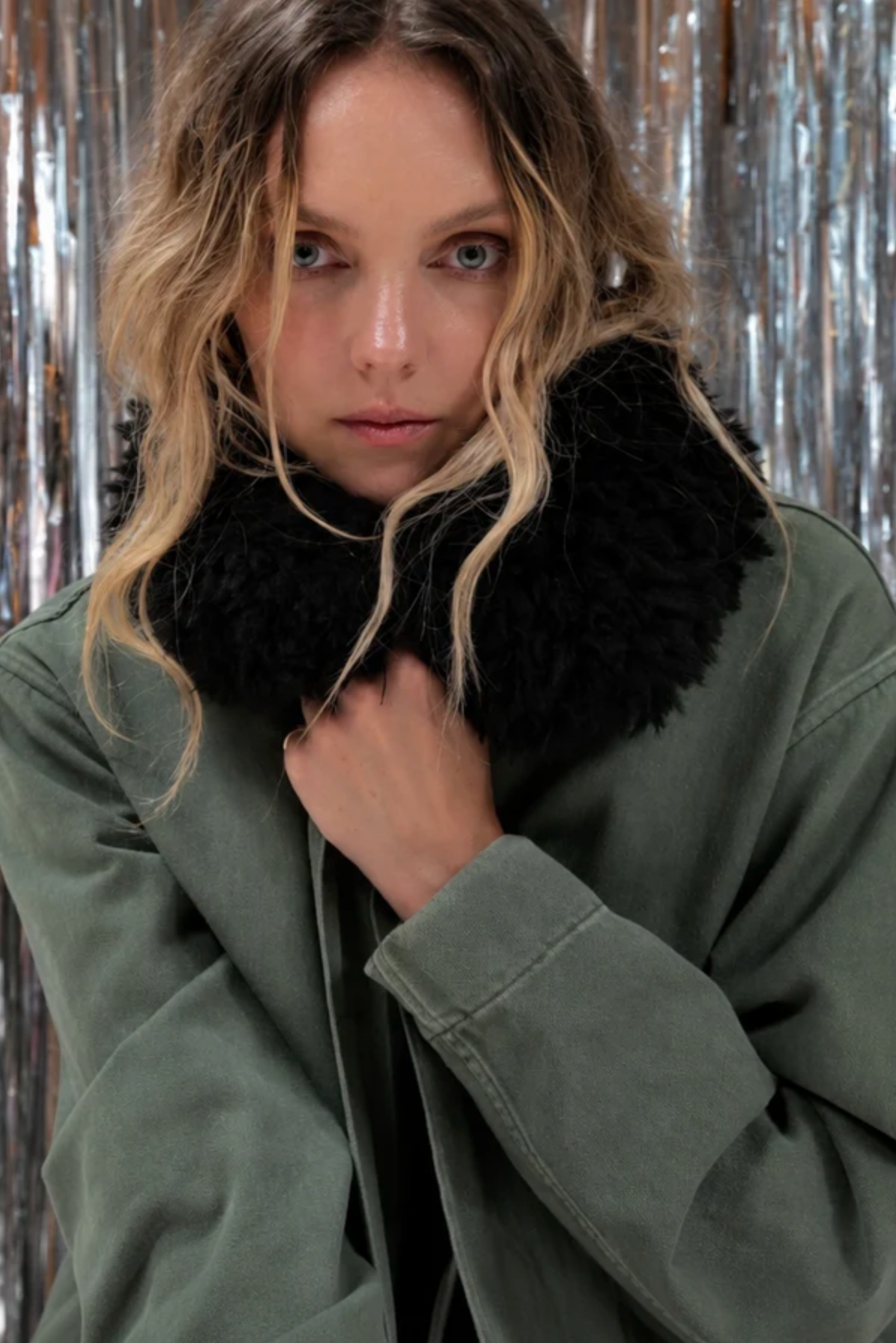 Le Superbe utility anorak in olive green with an oversized black faux-fur collar.