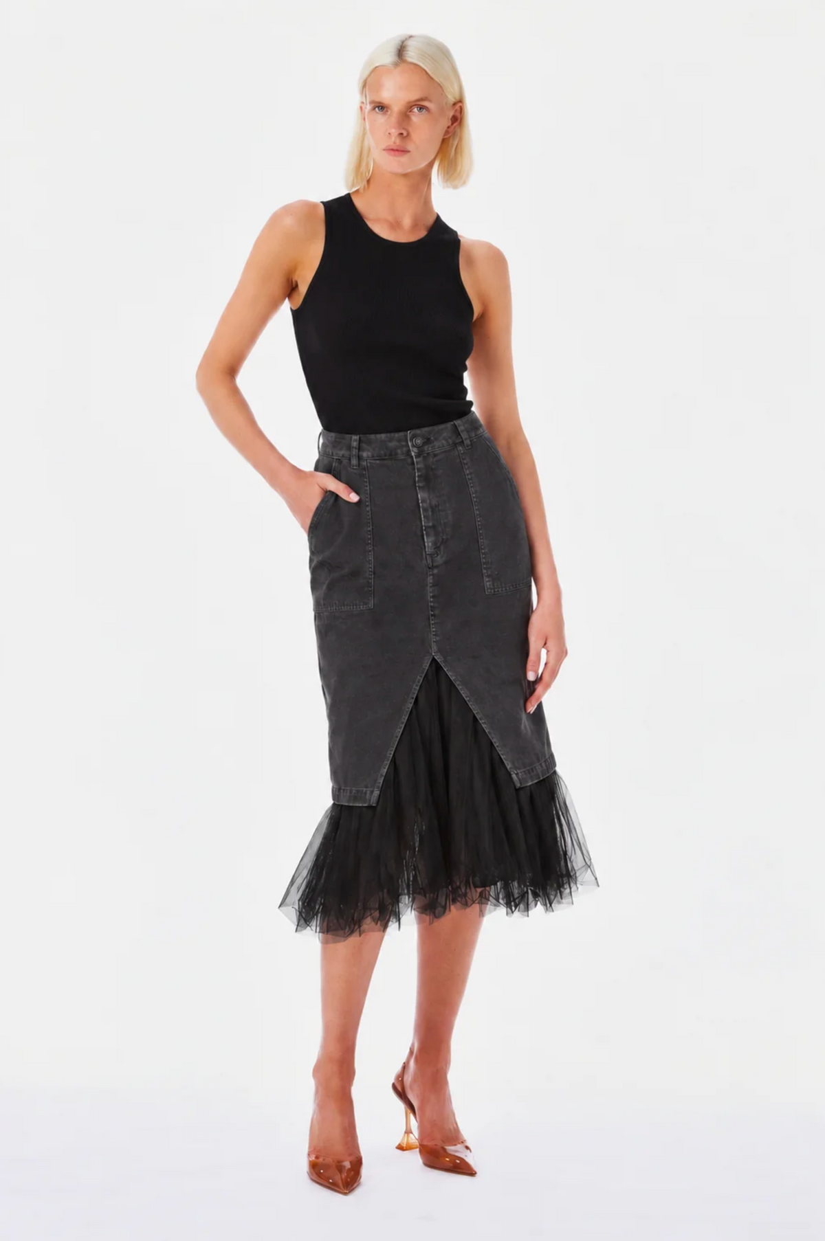 Black denim midi skirt by Le Superbe, featuring high-waist, front pockets, center slit, and black tulle hem.